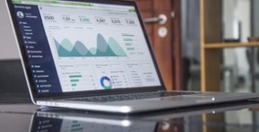 a laptop showing data graphics